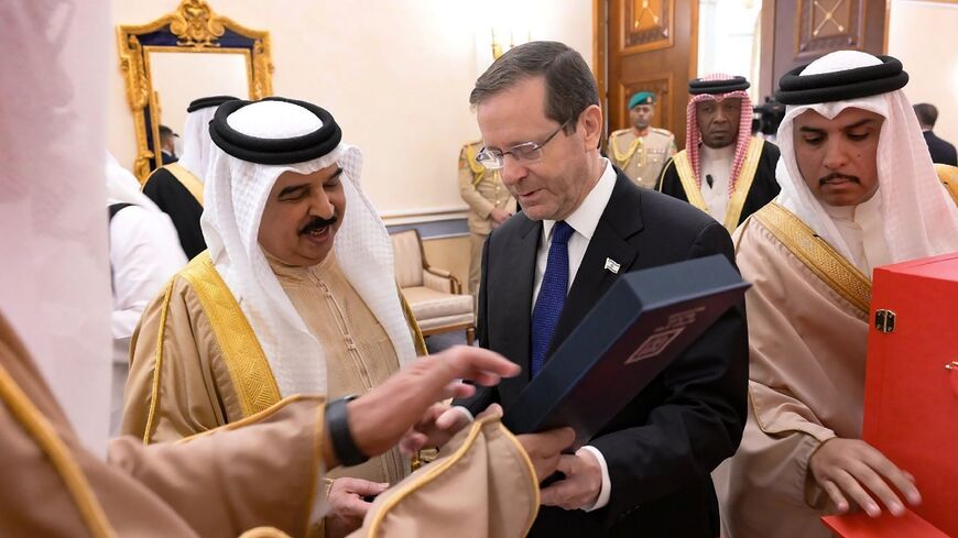 Bahrain's King Hamad bin Isa al-Khalifa receives a gift from Israeli President Isaac Herzog 