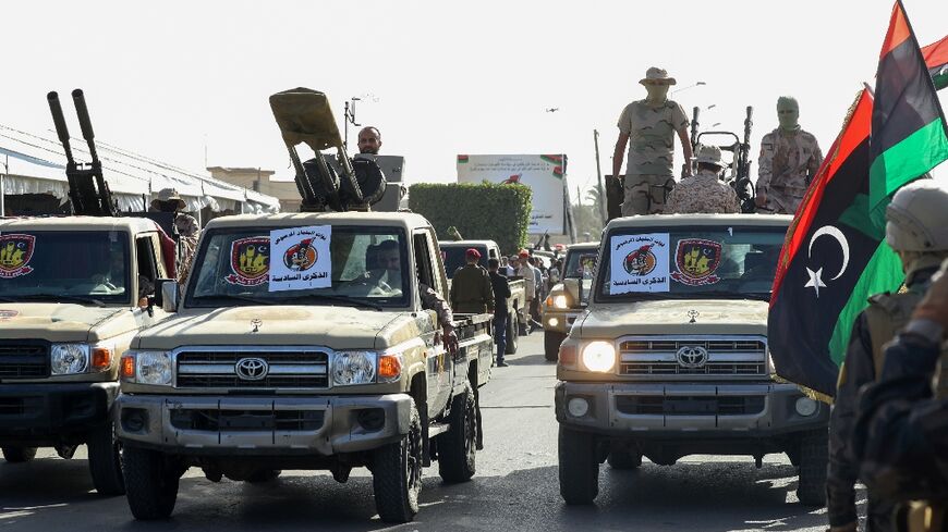 Libyan security forces affiliated with Tripoli-based interim Prime Minister Abdelhamid Dbeibah take part in a parade marking the 6th anniversary of the “liberation of Sirte” from Islamic State (IS) group on December 17