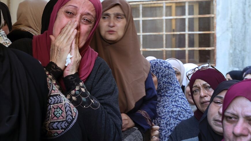 Palestinian mourners cry during the funeral of militant Muhammad Ayman al-Saadi, 26