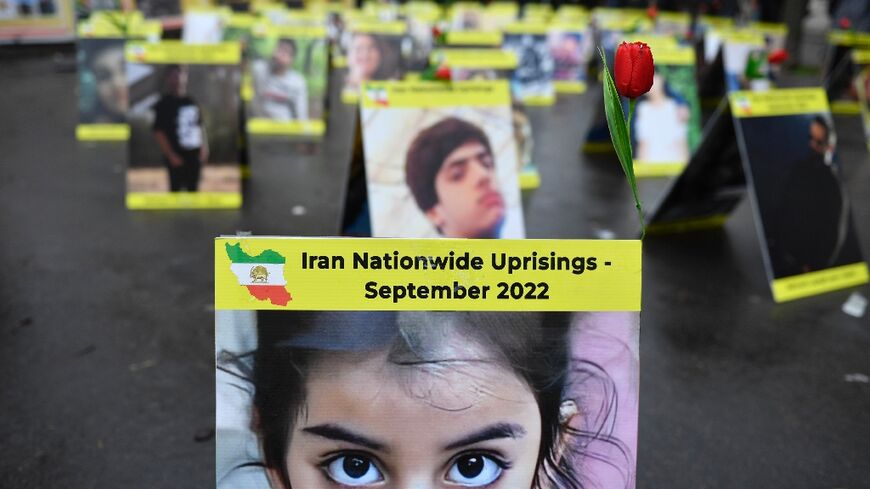 Placards with portraits of the victims of Iran's repression are seen on display near the French National Assembly