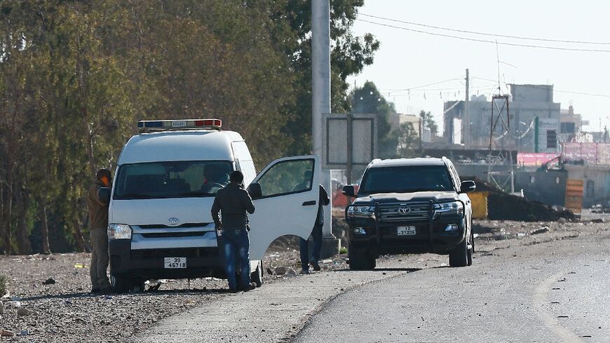 A forensic team collects evidence in Maan, Jordan,  after a senior police officer was shot dead 