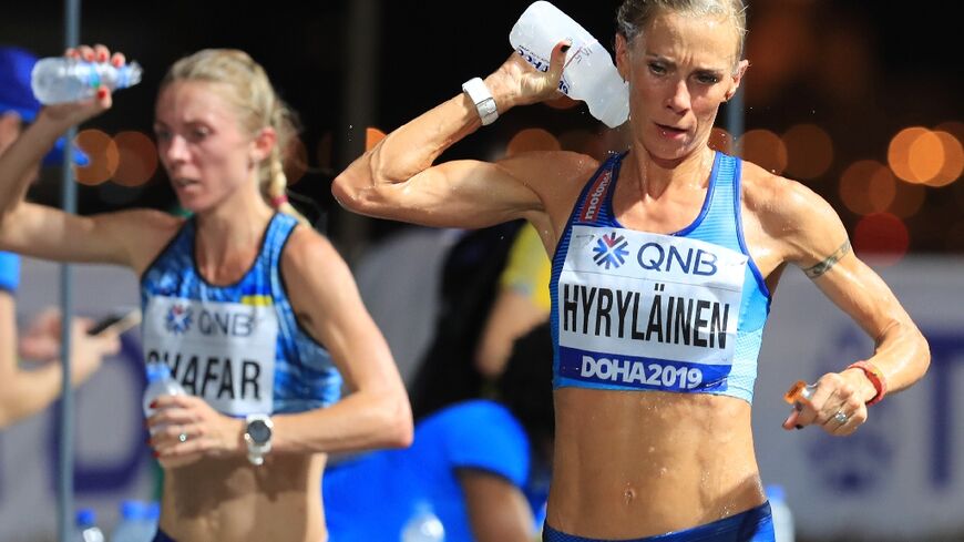 Feeling the heat: Finland's Anne-Mari Hyrylainen competes in sweltering conditions in Doha at the 2019 World Championships; experts say an air-conditioned marathon course is possible if Doha bids for the Olympics