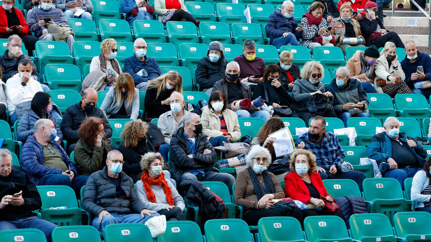 Israelis who were allowed to enter an arena after showing proof of being fully vaccinated against the coronavirus attend a "Green Pass" concert for vaccinated seniors, organized by the municipality of Tel Aviv, Israel, Feb. 24, 2021.