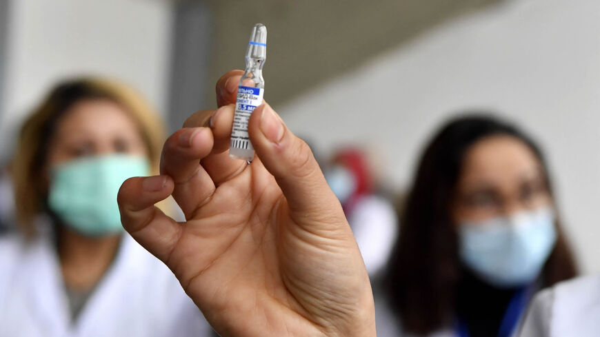 A nurse shows a vial of the Russian Sputnik V vaccine against the coronavirus at a hospital at the start of a vaccination program, Tunis, Tunisia, March 13, 2021.