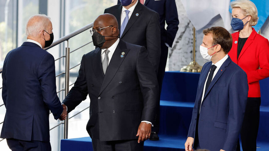 US President Joe Biden (L) shakes hands with African Union President of the Democratic Republic of Congo Felix Tshisekedi as French President Emmanuel Macron (2nd R) and President of the European Commission Ursula von der Leyen look on at the start of the G-20 Summit, Rome, Italy, Oct. 30, 2021.