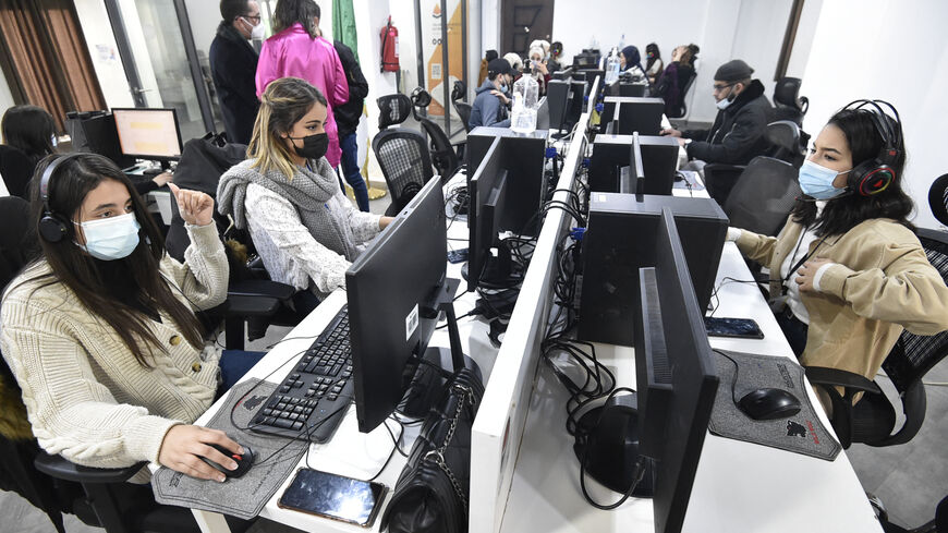 Employees work at the call centre of the Algerian delivery company Yassir, at the company's headquarters , in the capital Algiers on February 23, 2022. - It's the Algerian start-up that made good: despite the country's notoriously complex business climate, taxi and home-delivery firm Yassir has millions of users and is expanding across Africa.