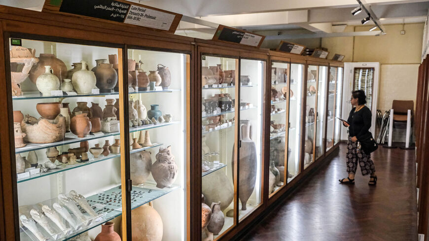 A visitor views artefacts in one of the galleries of the Petrie Museum of Egyptian Archaeology at University College London, United Kingdom, July 28, 2022.
