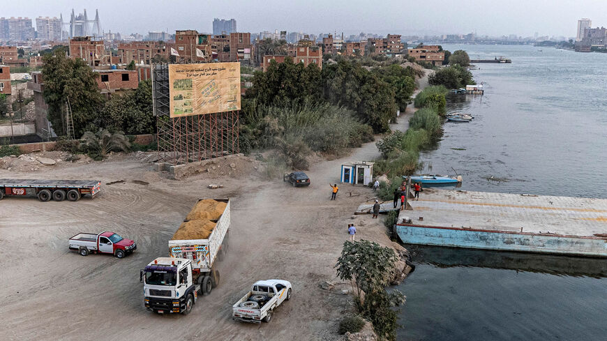 A trailer truck filled with sand waits near a dock at the construction site of new residential towers on the Nile island of Warraq in Giza province, opposite the northern shore of Cairo, the slums of which are planned for development by the Egyptian government, Egypt, Aug. 31, 2022.