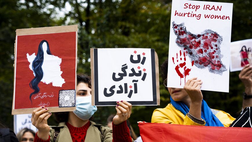 Protesters hold placards during a rally against Iranian regime outside the House of Representatives in The Hague on September 23, 2022, following the death of an Iranian woman after her arrest by the country's morality police in Tehran. (Photo by LEX VAN LIESHOUT/ANP/AFP via Getty Images)