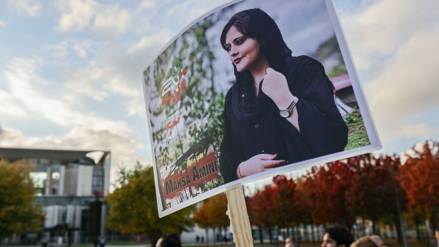 Demonstrators, some hold banners with the image of Mahsa Amini, march by the federal chancellery in solidarity with protesters in Iran on October 15, 2022 in Berlin, Germany.(Photo by Omer Messinger/Getty Images)