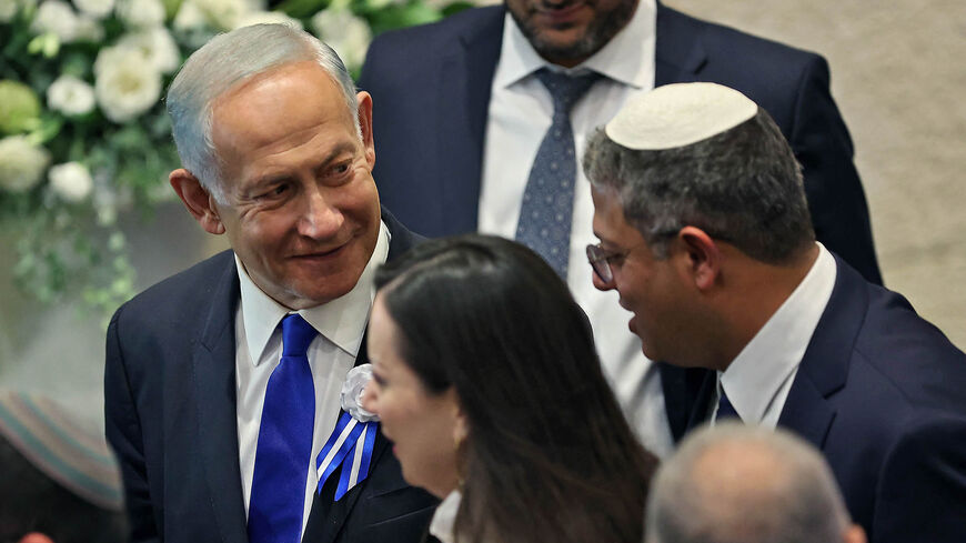Israeli right-wing Knesset member Itamar Ben-Gvir (R) chats with incoming Prime Minister Benjamin Netanyahu (L) during the swearing in ceremony of the new Israeli government at the Knesset, Jerusalem, Nov. 15, 2022.