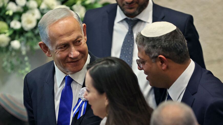 Israeli right-wing Knesset member Itamar Ben-Gvir (R) chats with incoming Prime Minister Benjamin Netanyahu (L).