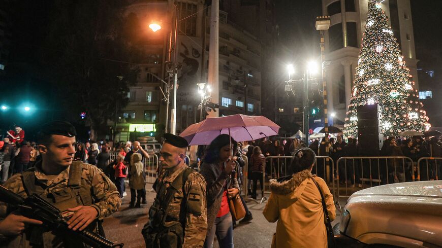 Security forces stand guard during the lighting of the Christmas tree in Sassine Square in the Ashrafieh district of Lebanon's capital Beirut on December 7, 2022. (Photo by ANWAR AMRO/AFP via Getty Images)