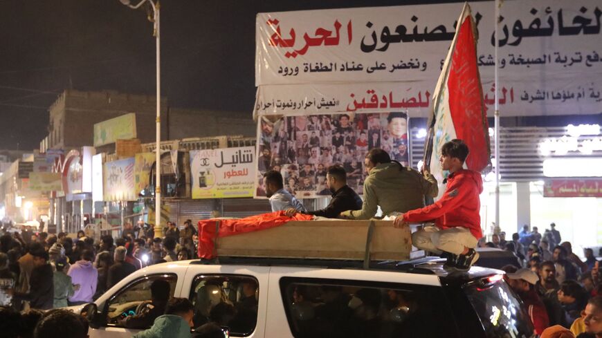 Mourners accompany the casket of one of the two protesters killed earlier in clashes.