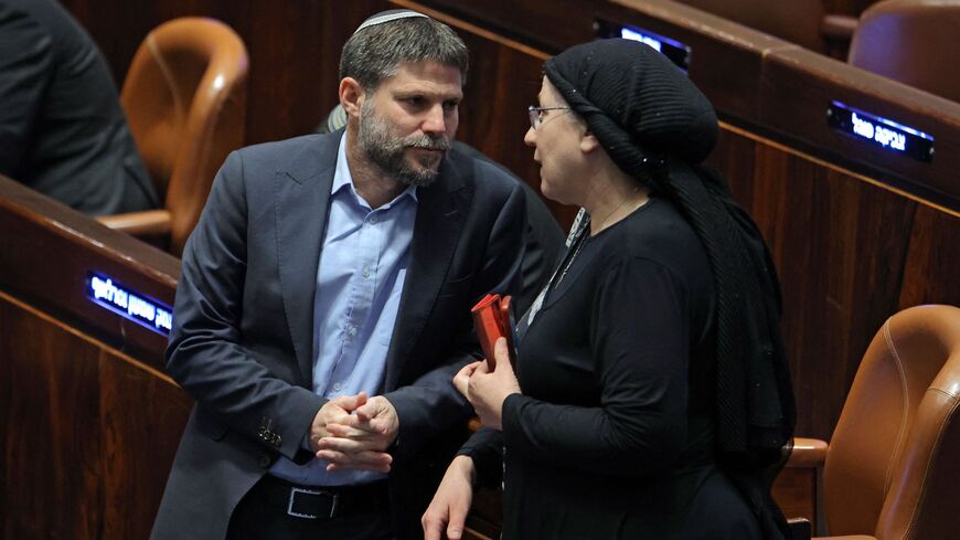 Israeli Knesset (Israeli parliament) member Bezalel Smotrich (L), leader of the Religious Zionist Party, speaks with his colleague and party member Orit Strook (R).