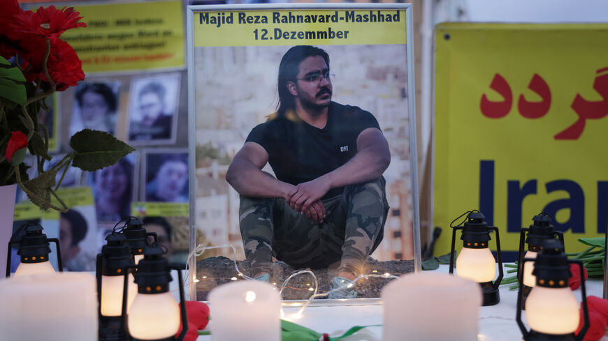 A photograph of Majid Reza Rahnavard, 23, stands on a table among candles during a demonstration by supporters of the National Council of Resistance of Iran outside the German Foreign Ministry on December 12, 2022 in Berlin, Germany.  (Sean Gallup/Getty)
