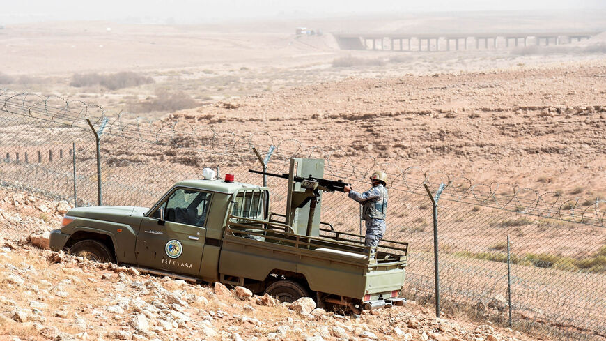A Saudi soldier mans a turret on a border guards' vehicle as it patrols the fence separating Saudi Arabia and Iraq, in the area around Arar city along the Saudi-Iraq border, March 12, 2017.