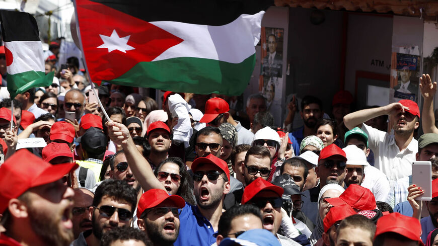 Jordanian protesters wave national flags and shout slogans during an anti-austerity rally, in front of the Labor Union offices, Amman, Jordan, June 6, 2018.