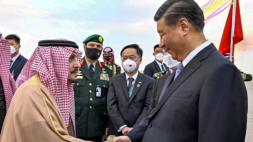 China's President Xi Jinping (R) greeted by the Governor of Riyadh province Prince Faisal bin Bandar al-Saud (L) at King Khalid International Airport