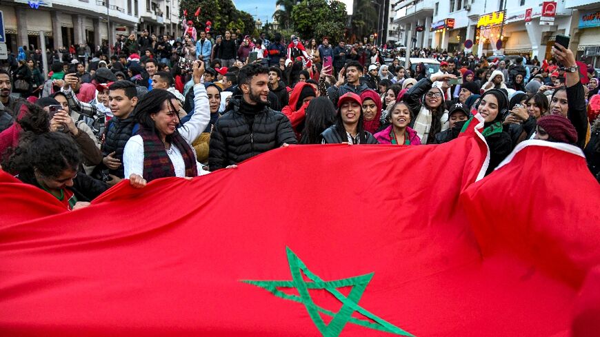 Moroccan fans celebrate in the capital Rabat after their team became the only one from an Arab nation to reach the World Cup second round