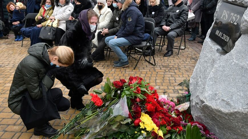 Women in Kyiv lay flowers to commemorate the crew and passengers of Ukraine International Airlines Flight 752, which was shot down by Iran