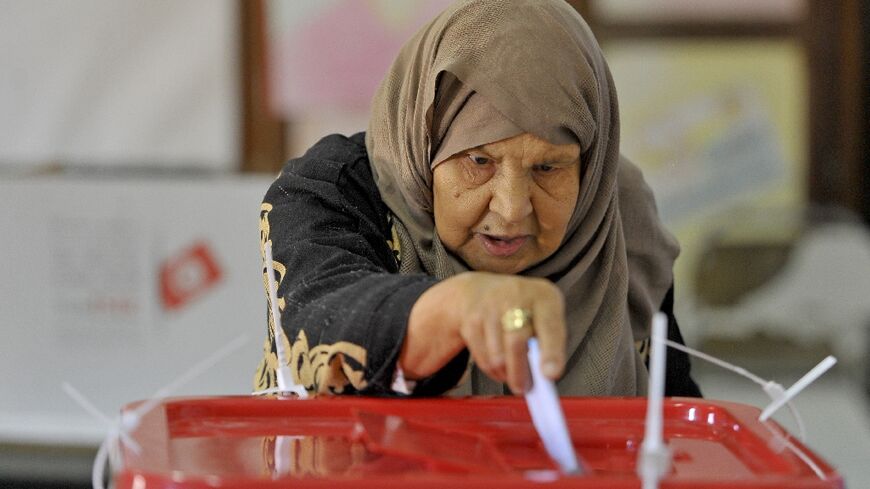 In Ben Arous region near Tunis, a Tunisian voter casts her ballot -- most parties were boycotting the vote
