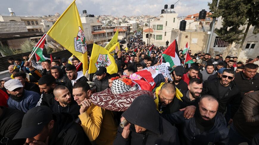 Palestinians attend the funeral proccession for Ahmad Kahla in the village of Rammun in the occupied West Bank