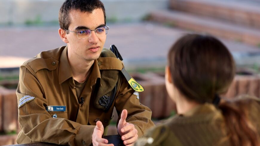 Israeli army soldier Nathan Saada, 20, on the left, is part of a programme allowing people with autism to serve in the military