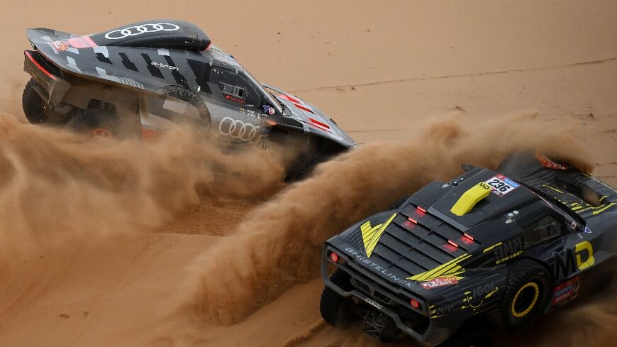 Carlos Sainz in his Audi passing Simon Vitse on the eight stage of the Dakar Rally