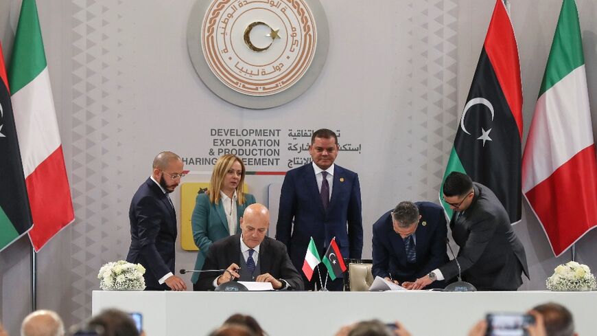 Eni CEO Claudio Descalzi (front L) signs a $8 billion deal with Libyan National Oil Corporation chief Farhat Bengdara (2nd R) to develop two offshore gas fields