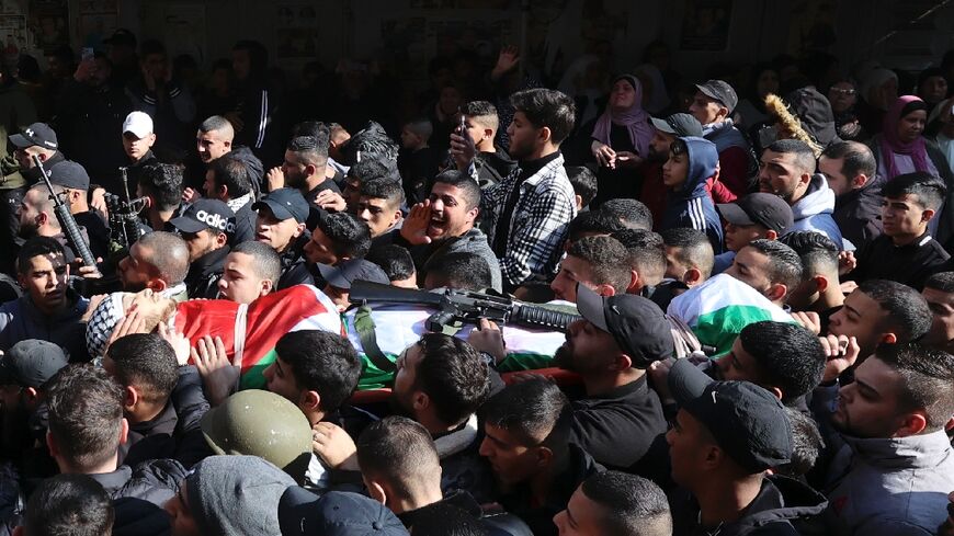 Palestinian mourners and gunmen attend the funeral of Ahmed Abu Junaid, whom the Al-Aqsa Martyrs' Brigade claimed as one of its members