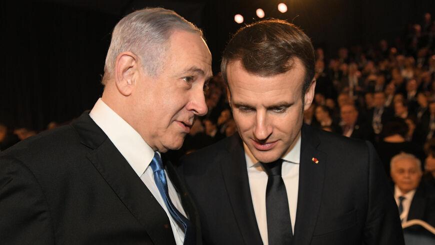 Israeli Prime Minister Benjamin Netanyahu speaks with French President Emmanuel Macron.