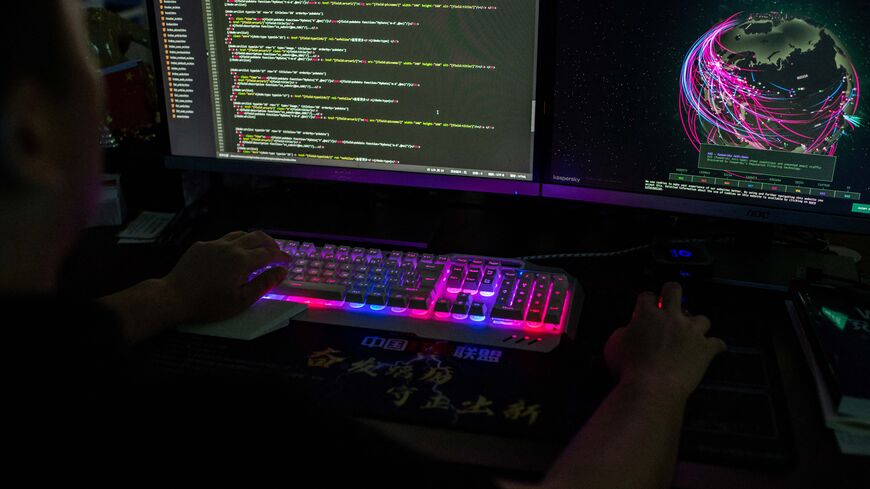 This photo taken on August 4, 2020 shows Prince, a member of the hacking group Red Hacker Alliance who refused to give his real name, using a website that monitors global cyberattacks on his computer at their office in Dongguan, China's southern Guangdong province. (Photo by NICOLAS ASFOURI/AFP via Getty Images)