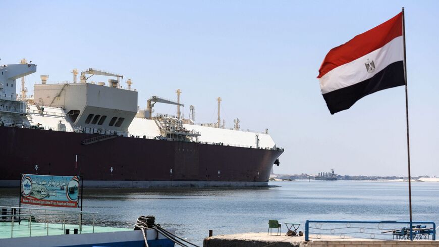An Egyptrian flag is pictured on the shore of the Suez Canal in the northeastern city of Ismailiya, on May 27, 2021. - Talks about compensations with the owner of the container ship Ever Given, that blocked the Suez Canal at the end of March are "at a standstill", Ossama Rabie, the head of the Egyptian authority that runs the Suez Canal said in an interview with AFP. The blocking that lasted six days, cost Egypt between 12 and 15 million USD per day of closure, according to the Suez Canal Authority (SCA). (