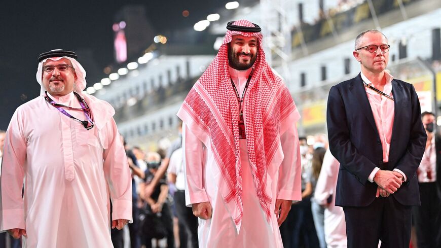 Saudi Arabian Crown Prince Mohammed bin Salman (C) and Formula One Group CEO Stefano Domenicali (R).