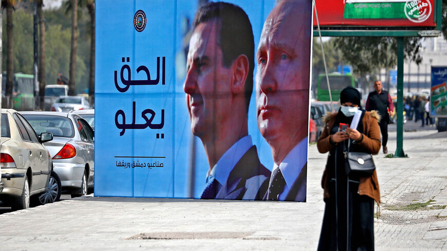 A banner depicting Syrian President Bashar al-Assad and Russian President Vladimir Putin reading "Justice Prevails" is displayed along a highway, Damascus, Syria, March 8, 2022.