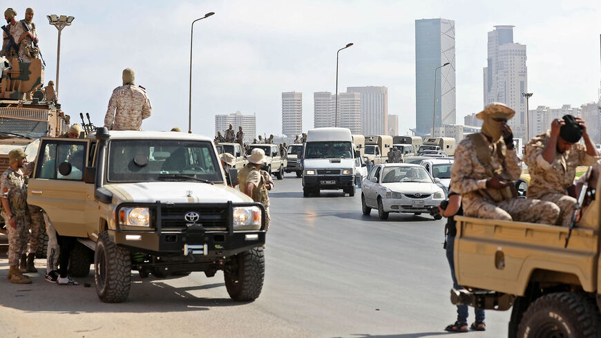 Vehicles of forces loyal to Tripoli-based Prime Minister Abdul Hamid Dbeibah are parked along the waterfront,  hours after forces of the rival Tobruk-based government withdrew following heavy fighting between opposing militiasTripoli, Libya, May 17, 2022.