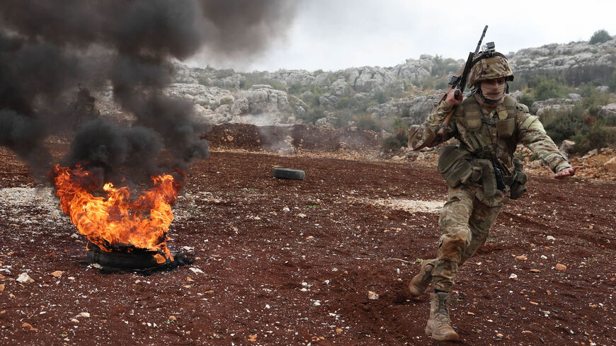 Fighters affiliated with Hayat Tahrir al-Sham take part in a military excercise on attacking tactics with live ammunition, on the outskirts of Idlib, Syria, Nov. 8, 2022.