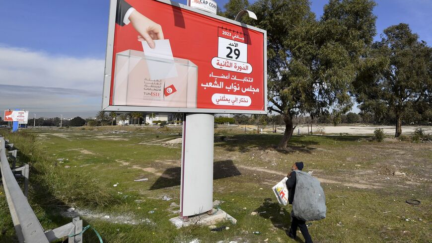 A man walks past an electoral billboard for the Tunisian national election scheduled for January 29, in Tunisia's capital Tunis, on January 25, 2023. (Photo by FETHI BELAID/AFP via Getty Images)