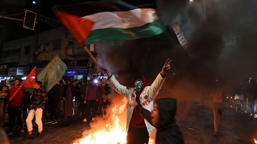 Palestinians celebrate in Gaza City on January 27, 2023, following a shooting attack by gunman outside an east Jerusalem synagogue. (Photo by MAHMUD HAMS/AFP via Getty Images)