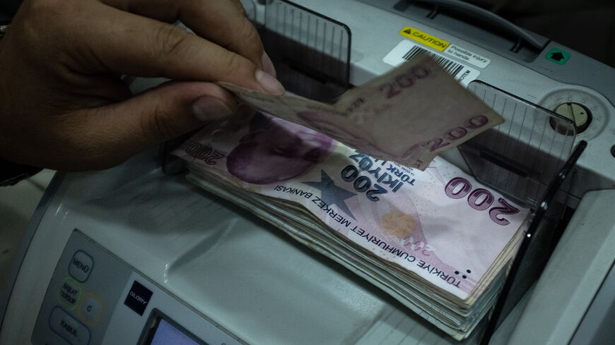 A man counts Turkish liras at a currency exchange office, Istanbul, Turkey, July 29, 2020.