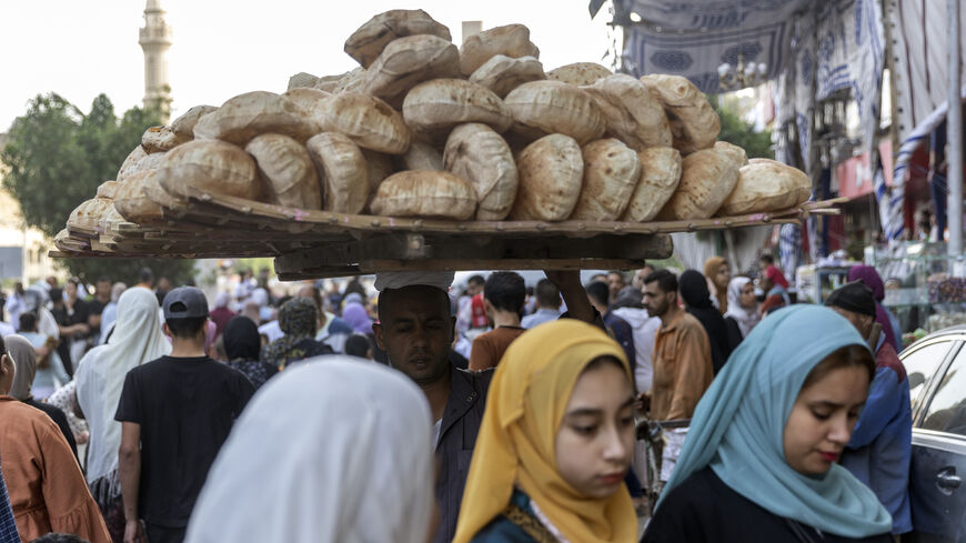 An Egyptian vendor carries a rack of Egyptian traditional 'Baladi' bread in Al Fustat neighborhood on May 2, 2022 in Cairo, Egypt. Egypt imports 80% of its wheat supply from Russia and Ukraine, whose production and export have been disrupted by the invasion. (Photo by Roger Anis/Getty Images)