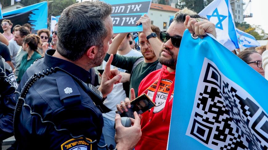 The demonstration blocked a road in Tel Aviv while some protesters held placards reading: 'No democracy, no high tech'