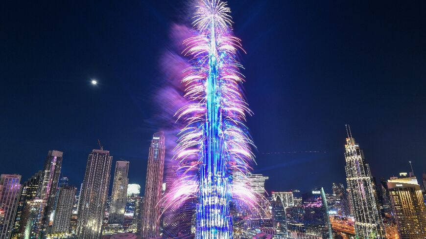 New Year's Eve fireworks light the landmark Burj Khalifa tower at midnight in the Gulf emirate of Dubai on December 31, 2022