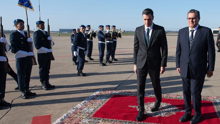 Morocco's Prime Minister Aziz Akhannouch (R) receives Spanish Prime Minister Pedro Sanchez upon his arrival in Rabat