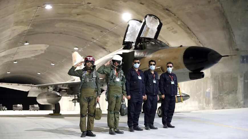 A handout picture provided by Iran's army shows pilots attending the unveiling of the country's first underground military base for fighter jets