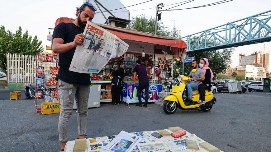 A man reads the Iranian newspaper Etemad, with the front page title reading in Farsi "The night of the end of the JCPOA ", and cover photos of Iran's Foreign Minister Hossein Amir-Abdollahian and his deputy and chief nuclear negotiator Ali Bagheri Kani, in the capital Tehran on Aug. 16, 2022.