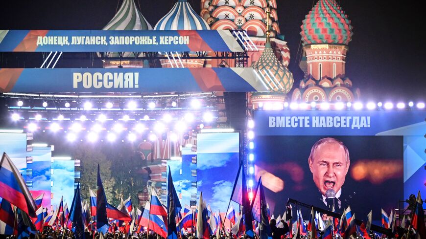 Russian President Vladimir Putin is seen on a screen set at Red Square as he addresses a rally and a concert marking the annexation of four regions of Ukraine Russian troops occupy - Lugansk, Donetsk, Kherson and Zaporizhzhia, in central Moscow on September 30, 2022. (Photo by ALEXANDER NEMENOV/AFP via Getty Images)