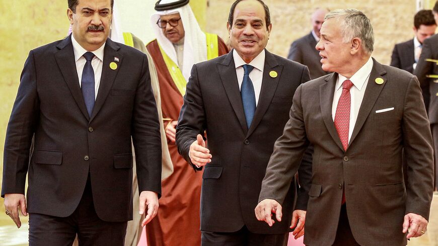 Jordan's King Abdullah II (R) escorts Egypt's President Abdel Fattah al-Sisi (C) and Iraq's Prime Minister Mohamed Shia al-Sudani (L) along with other dignitaries at the start of the "Baghdad Conference for Cooperation and Partnership" in Sweimeh by the Dead Sea shore in central-west Jordan on December 20, 2022. (Photo by KHALIL MAZRAAWI/AFP via Getty Images)
