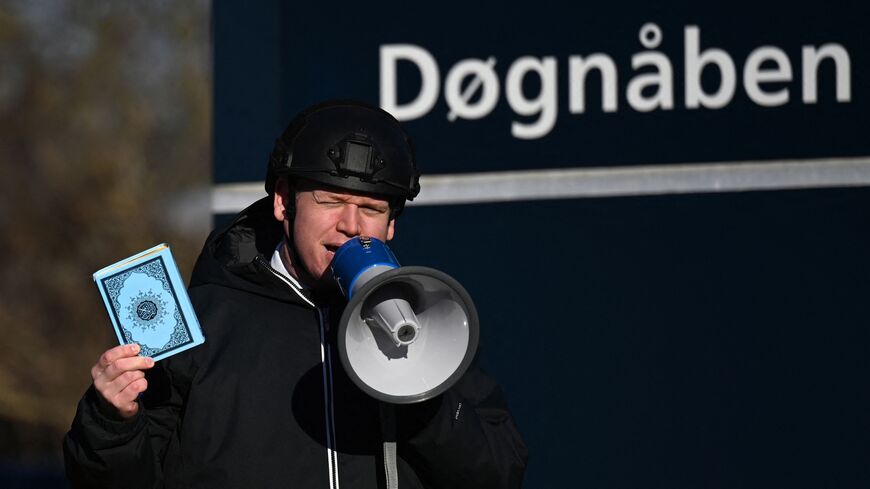 Far-right politician Rasmus Paludan holds up a Koran copy as he speaks in front of a mosque in Copenhagen, on January 27, 2023. - Turkey summoned Denmark's ambassador on January 27, 2023 to condemn a protest at which far-right extremist Paludan burned the Koran over Ankara's refusal to let Sweden and Finland join NATO. (Photo by SERGEI GAPON/AFP via Getty Images)